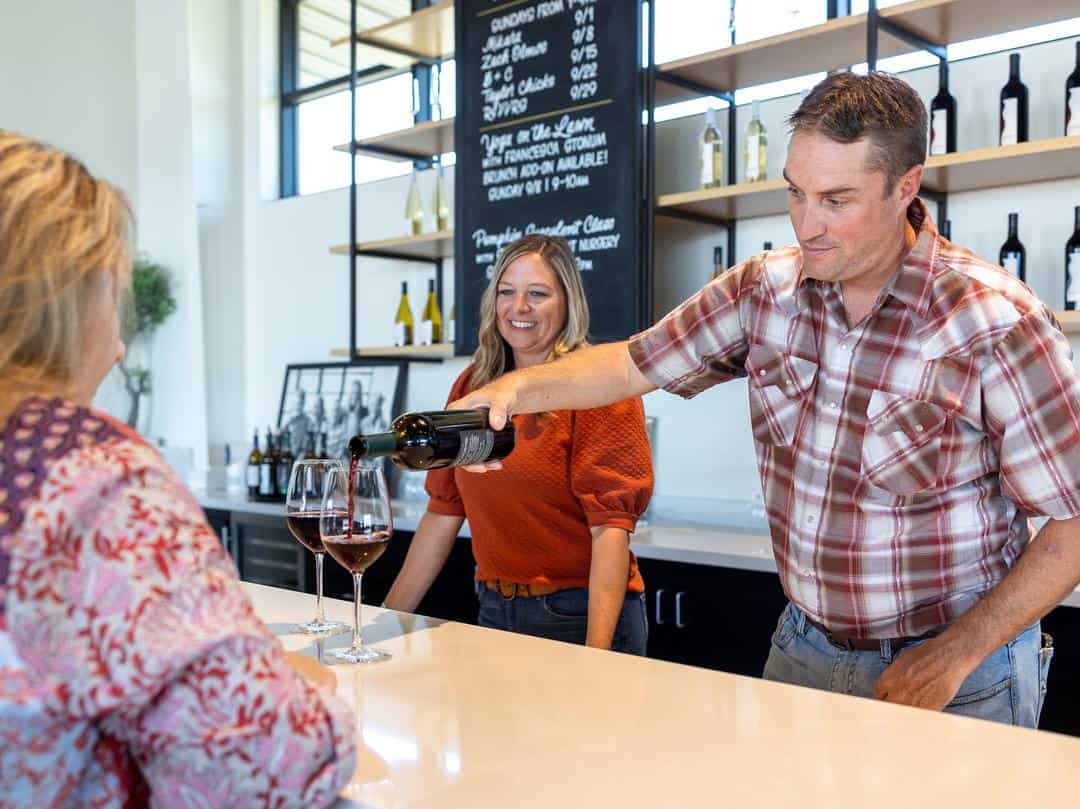 Mike and Julie pouring wine for the guests at their Lodi tasting room