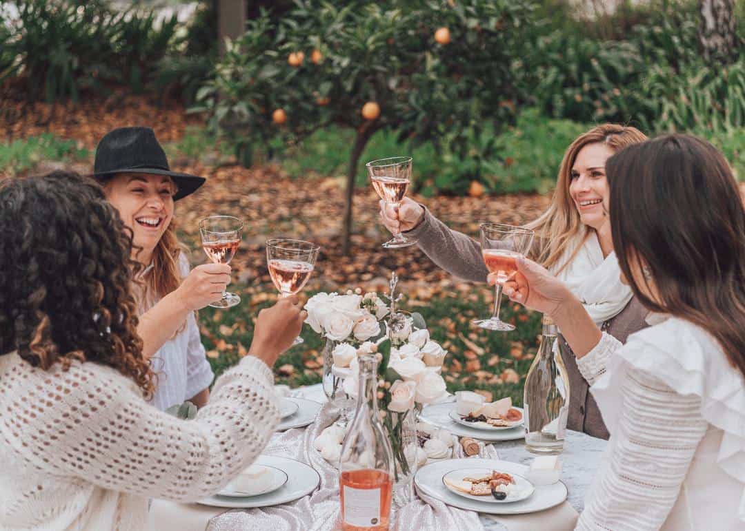 women toasting with Acquiesce Rose