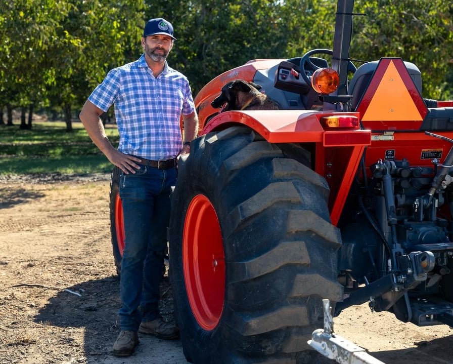 James Chinchioli standing next to a tractor