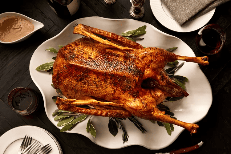 roast goose with on a white platter