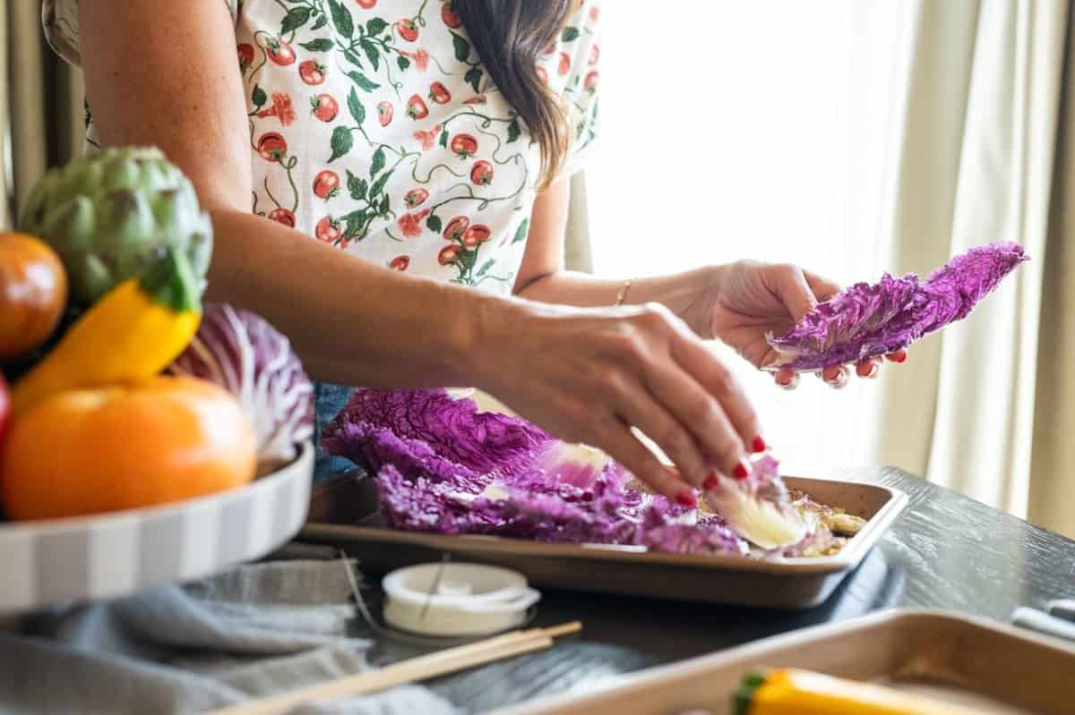 woman arranging cabbage leaves on platter