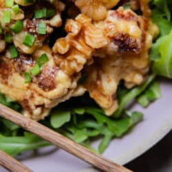 Close up of Honey Walnut Cauliflower over greens.