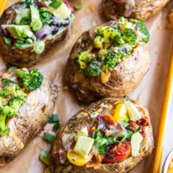 A variety of loaded baked potatoes.