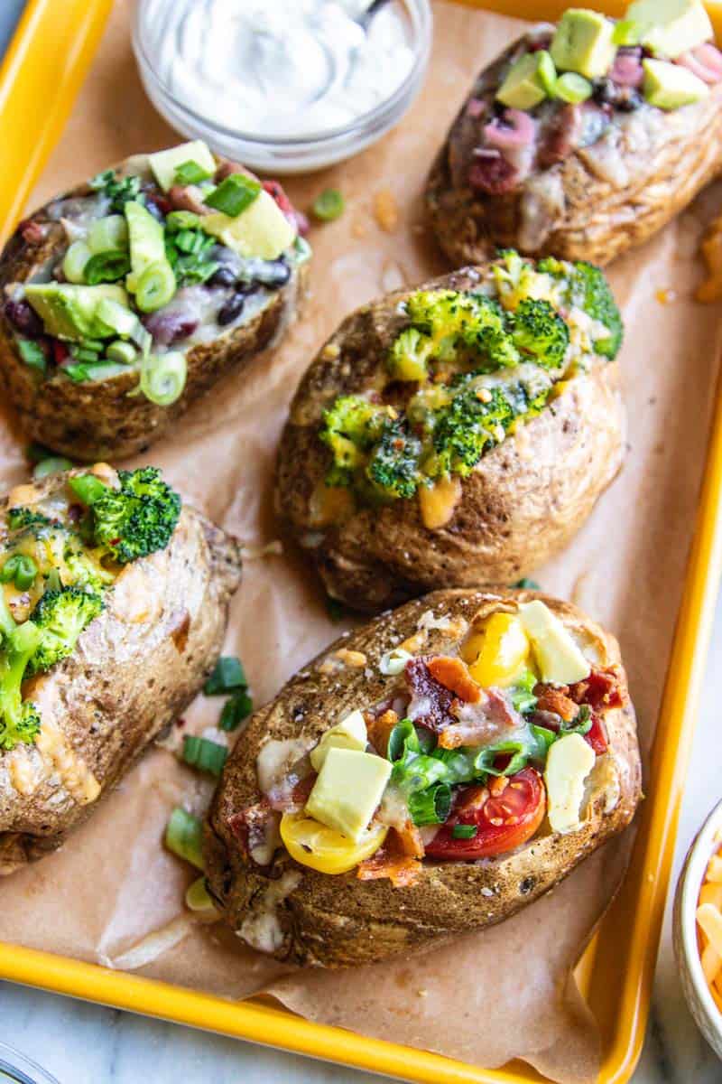 A variety of loaded baked potatoes.