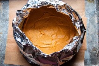 Persimmon pie wrapped in foil for baking.