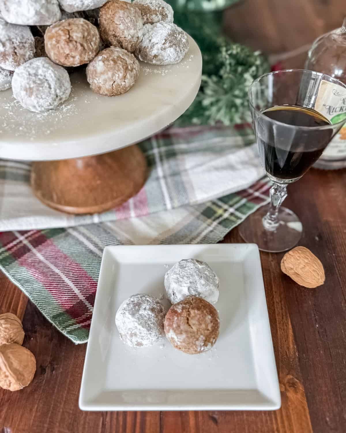 gluten free walnut cookies on a white square plate.