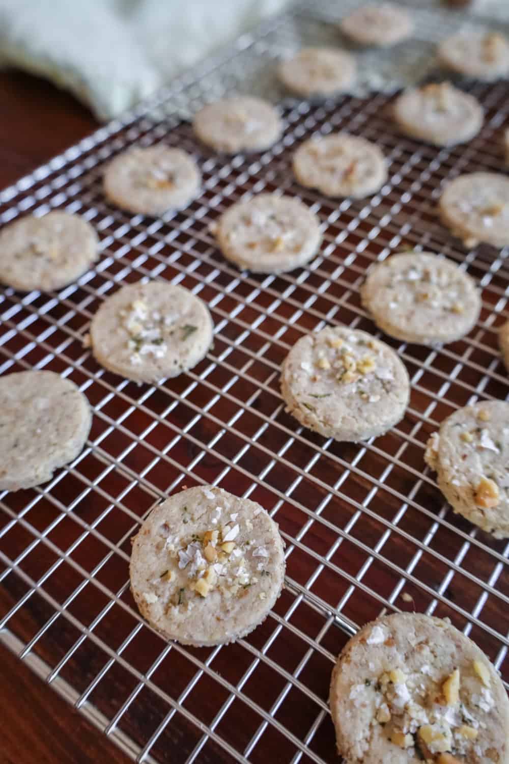 walnut crackers on a cooling rack after they are baked