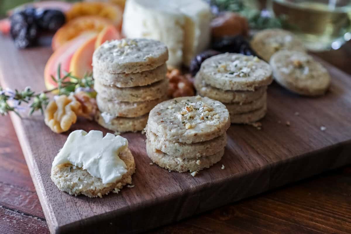 walnut homemade crackers on a cheeseboard topped with creamy california brie