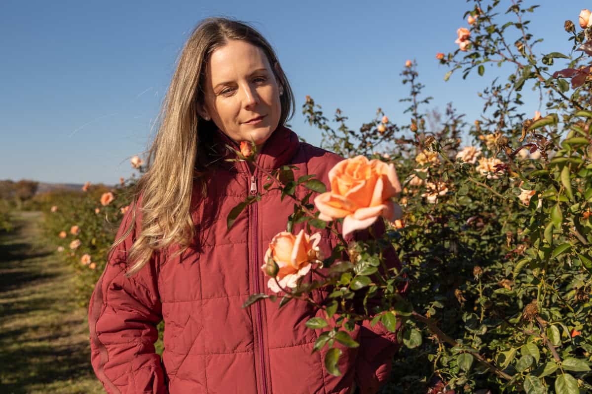 Felicia Alvarez walking through the roses at Menagerie Farm and Flower