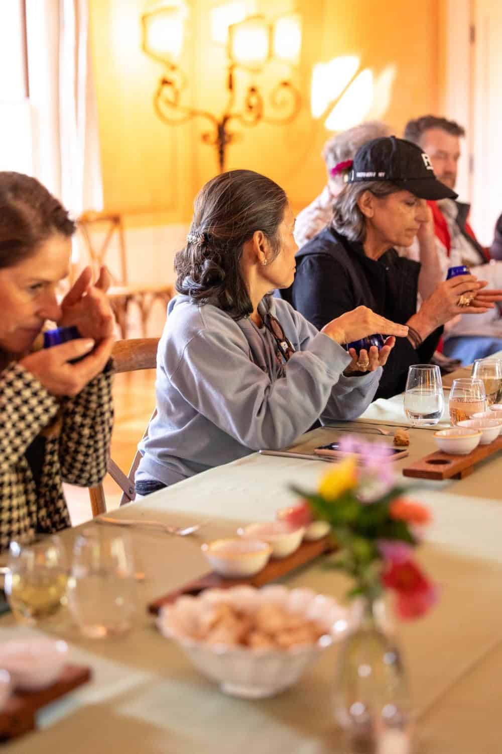 Guests warming and smelling the olive oil at McEvoy Ranch