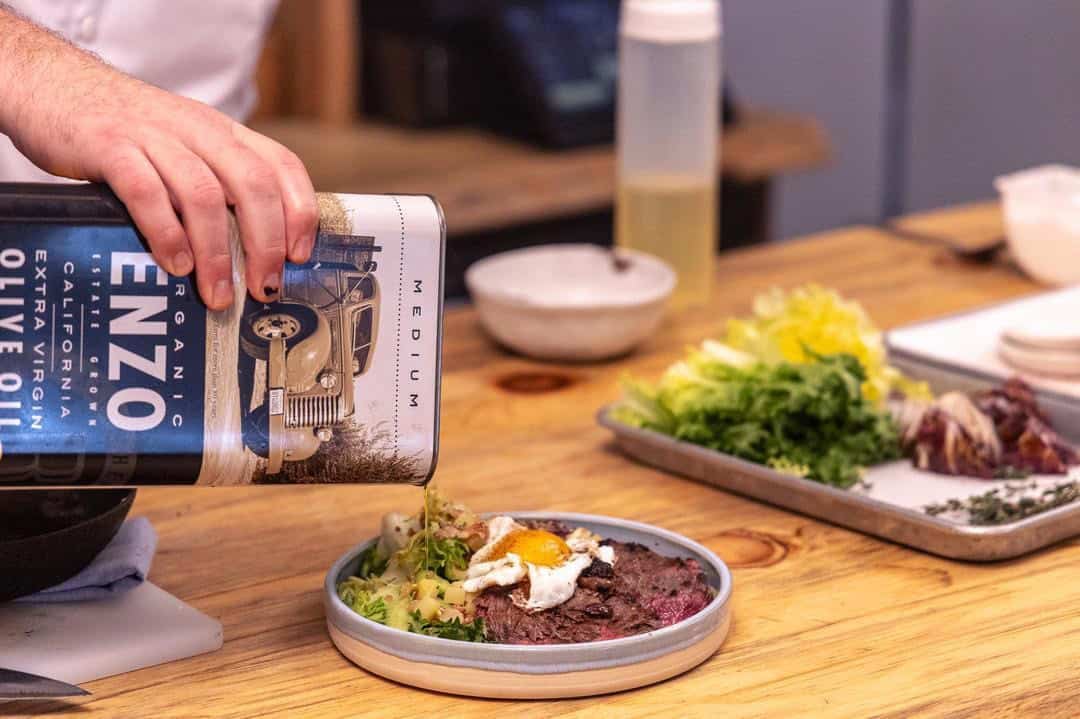 Pouring EVOO on top of the finished Beef Tagliata