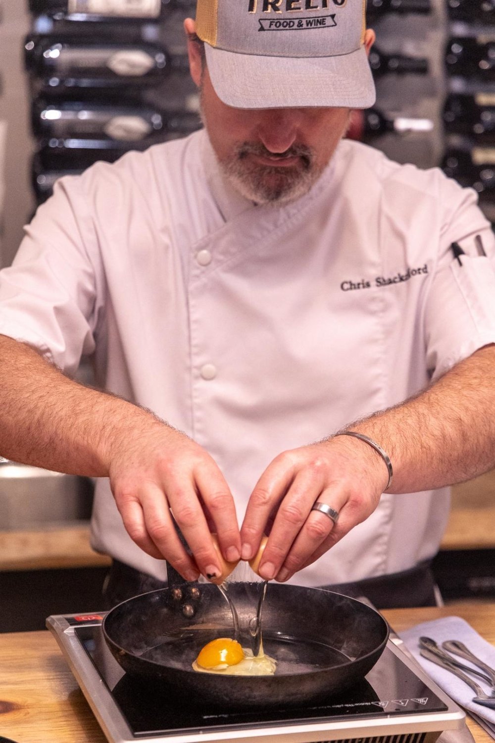 Chris Shackelford of Trelio cracking an egg into a fry pan