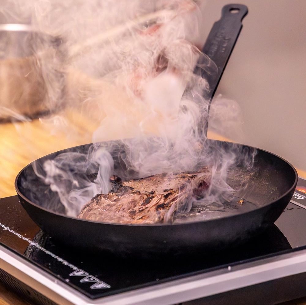 Steak cooking in a pan