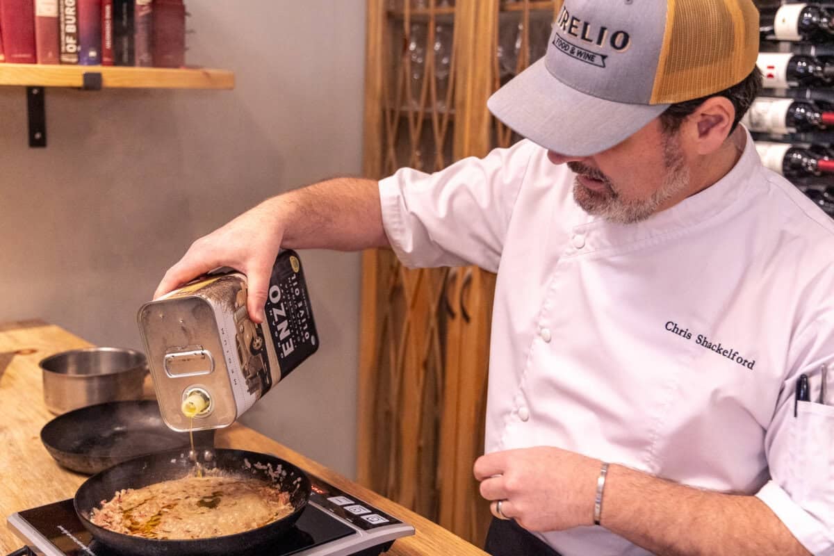 Pouring EVOO into a pan to finish the dressing for the Beef Tagliata