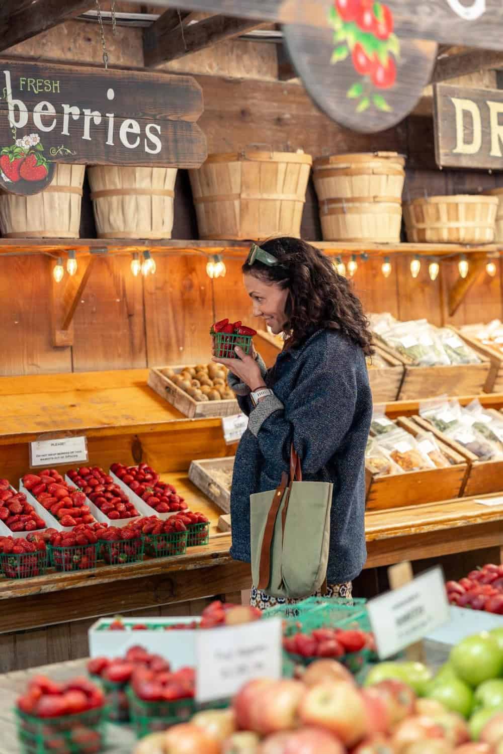 Aida Mollenkamp smelling the fresh strawberries at Avila Valley Barn