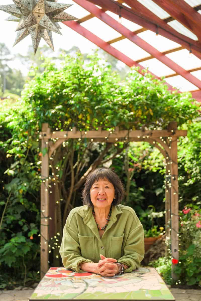 woman sitting under gazebo in outdoor patio