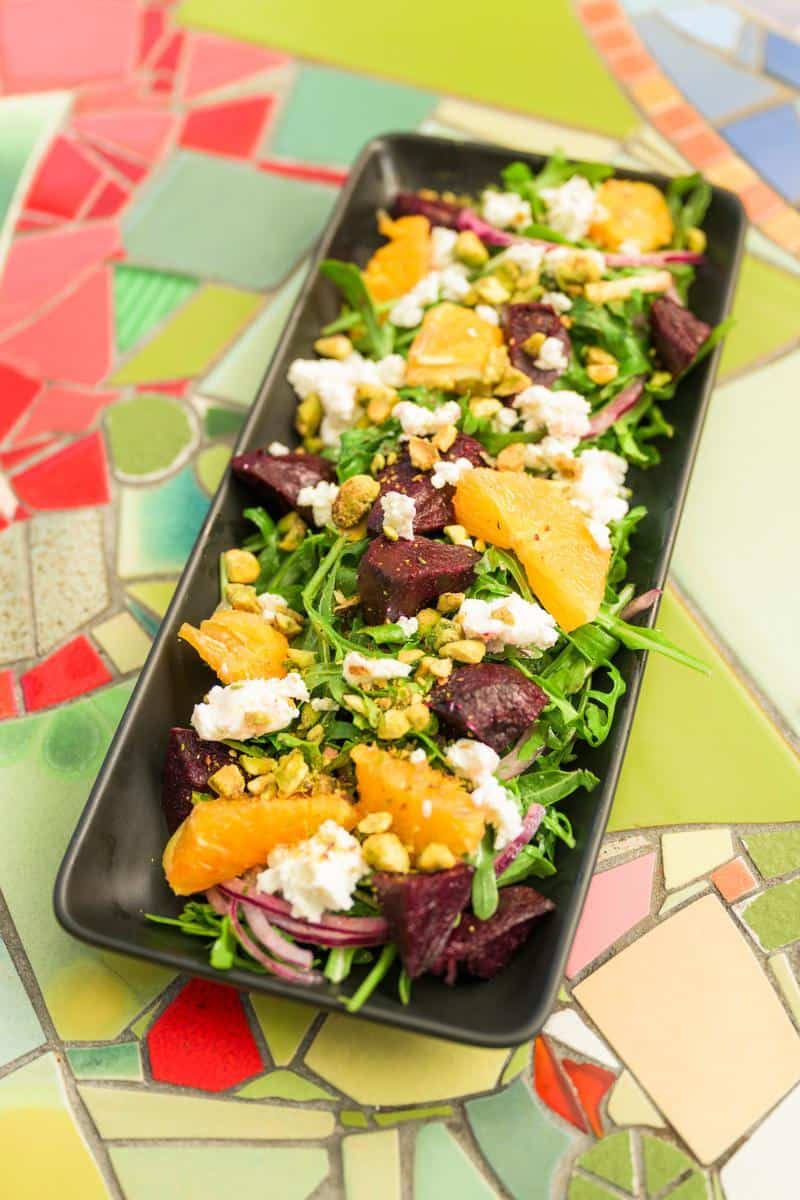 beet salad on a black rectangular plate from Robins