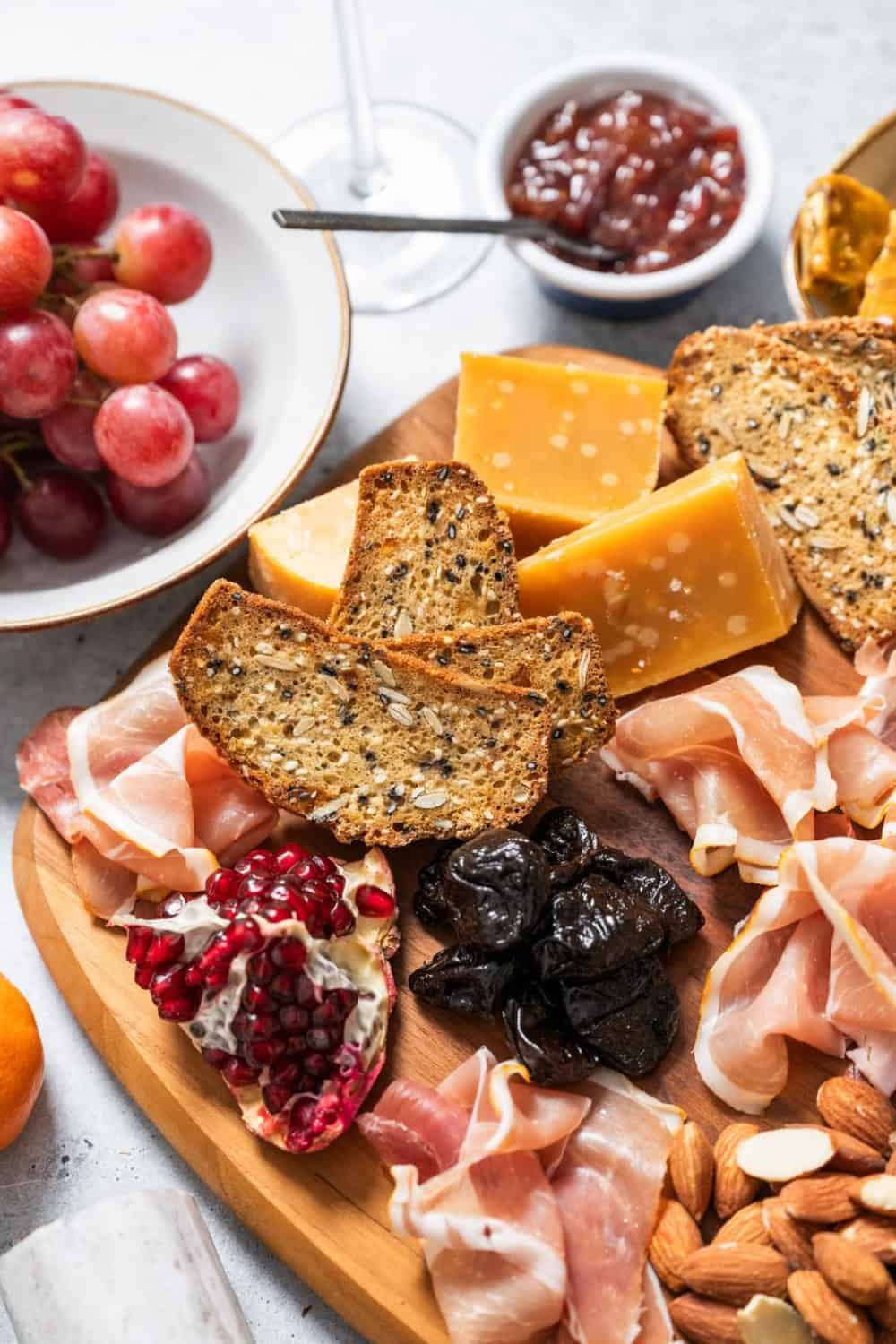 Cheeseboard with proscuitto, prunes, pomegranate and cheese
