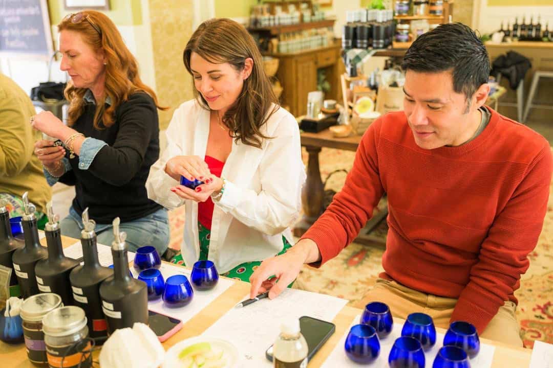 people tasting olive oil at pasolivo with a tasting sheet