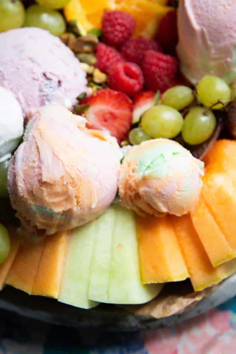 Scoops of rainbow sherbet on melon slices.