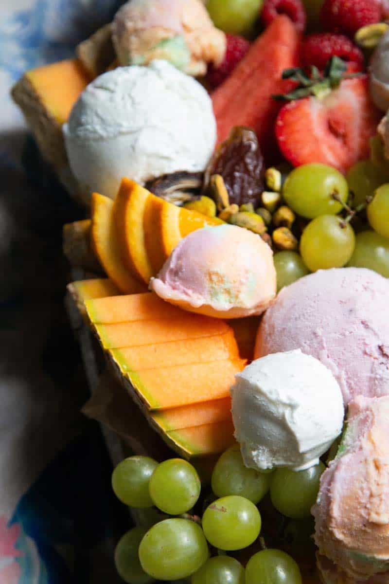 Close up of slices of melon and scoops of ice cream.