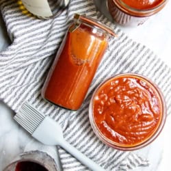 Red wine barbeque sauce in a few jars and a bowl.