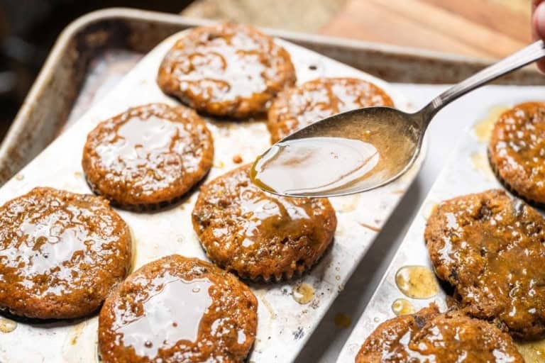 Adding glaze to cupcakes.