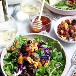 A table for two with roasted red cabbage wedges and white wine.