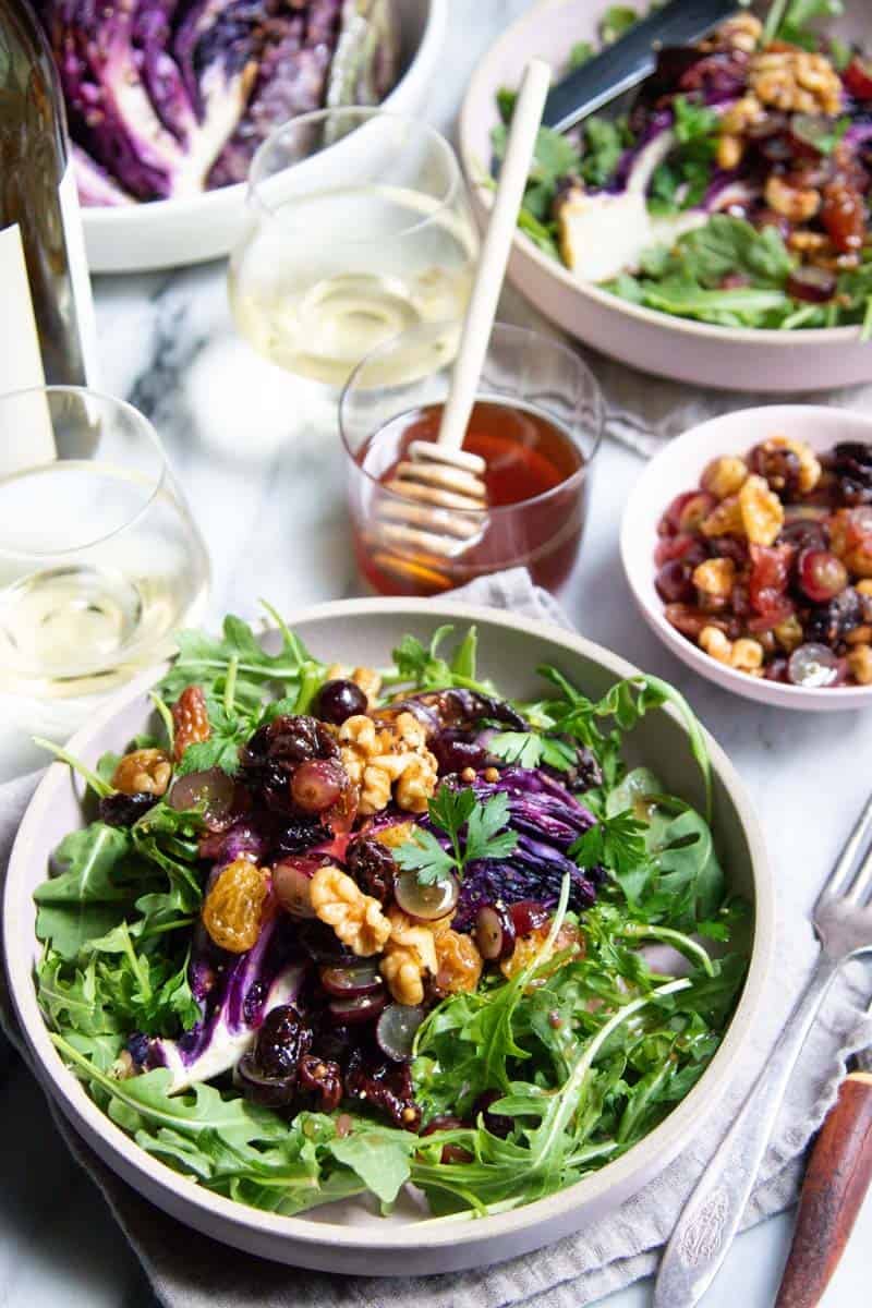 A table for two with roasted red cabbage wedges and white wine.