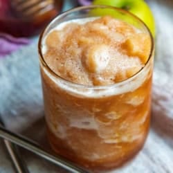 An apple cider slush in a glass to serve.
