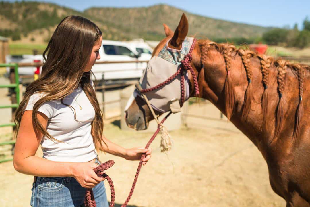 Francie Heffernan leading a horse at Five Marys Ranch 