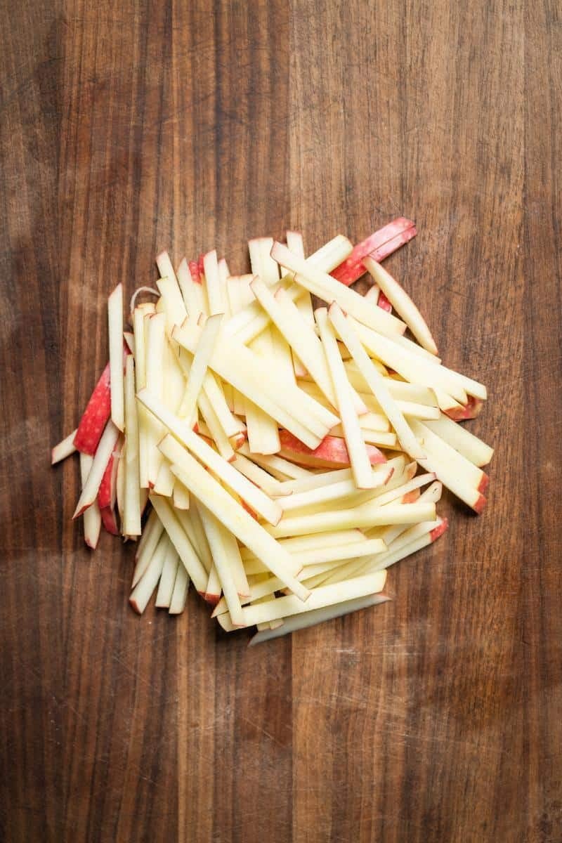 shaved apples on a cutting board