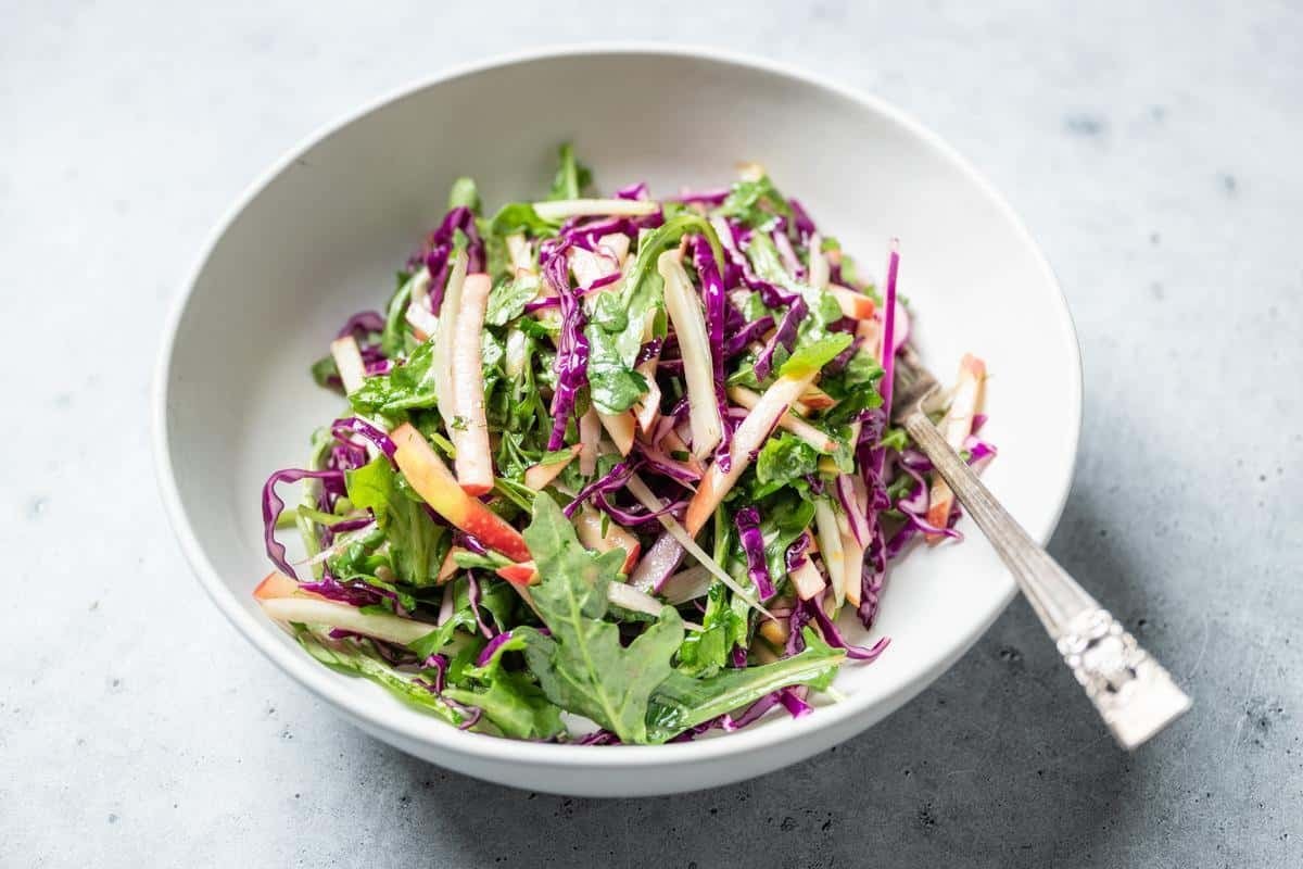 shaved apple fennel salad in a white bowl