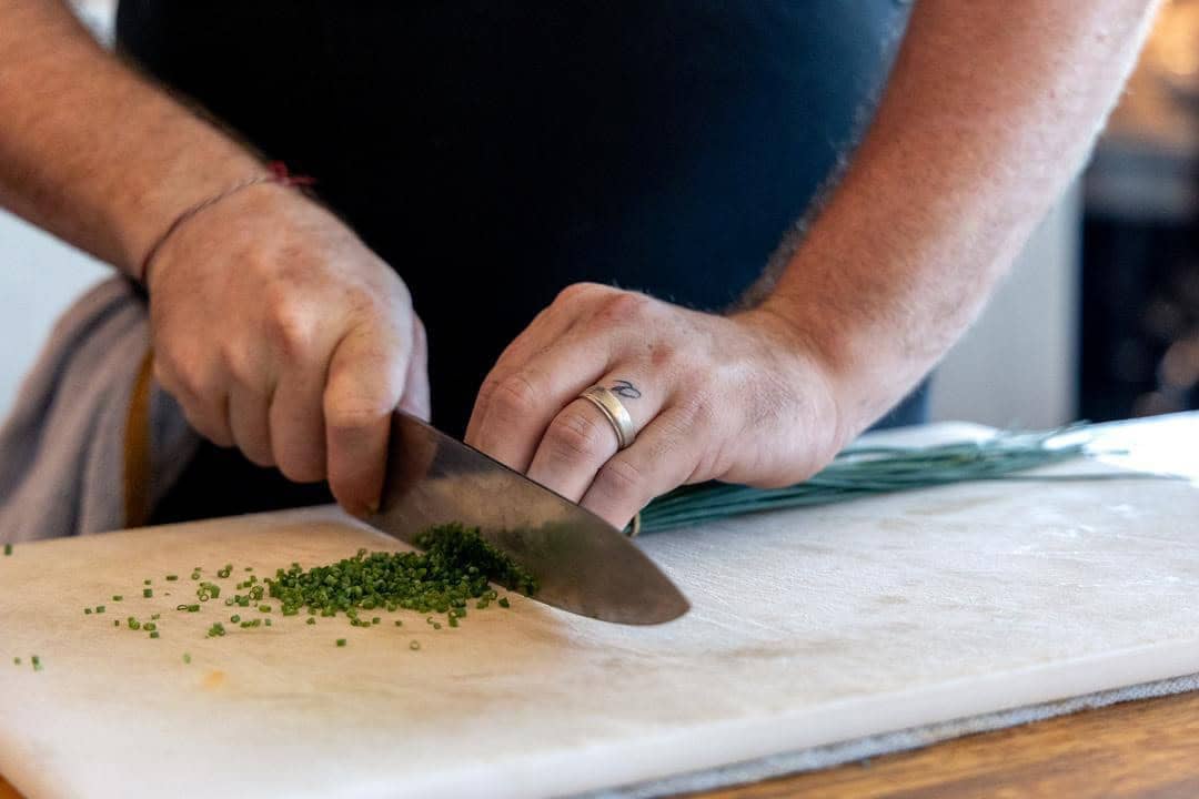 chef chopping chives at Franquette restaurant