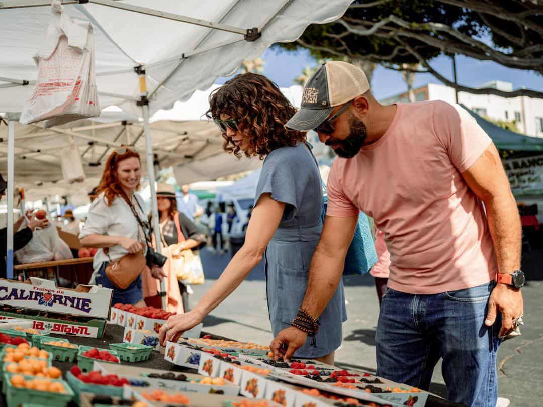 man and woman at a farmers market