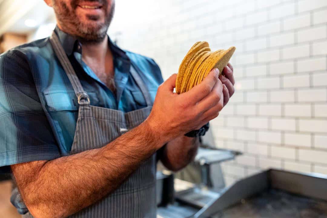 Patricio Wise holding homemade tacos at Nixtaco
