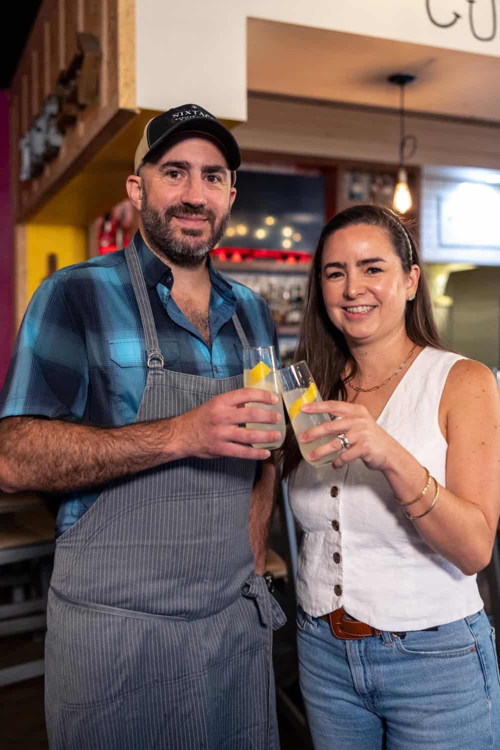 Cinthia Martinez and Patricio Wise toasting with a California 75 at Nixtaco