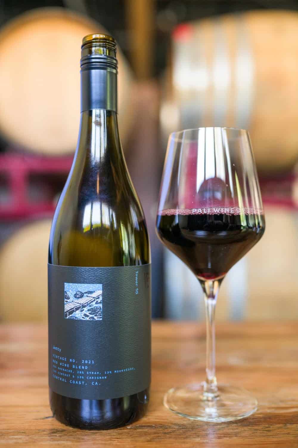bottle of red wine from Pali Wine Co. next to a glass poured 
