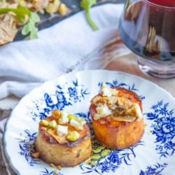A plate of melting sweet potato appetizers with a glass of red wine.