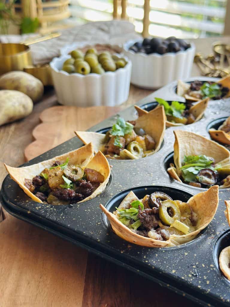 potato olive taco bites in a muffin tin 