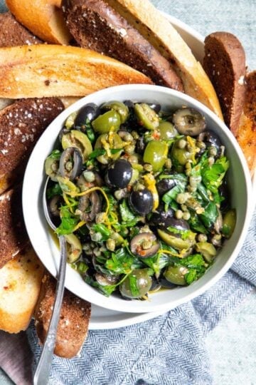 tapenade in a white bowl made with green and black olives