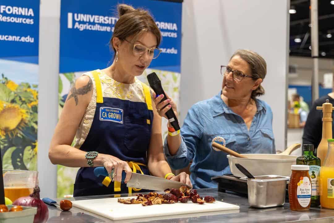 Meg and Diana demonstrating how to use jujubes at Terra Madre Americas