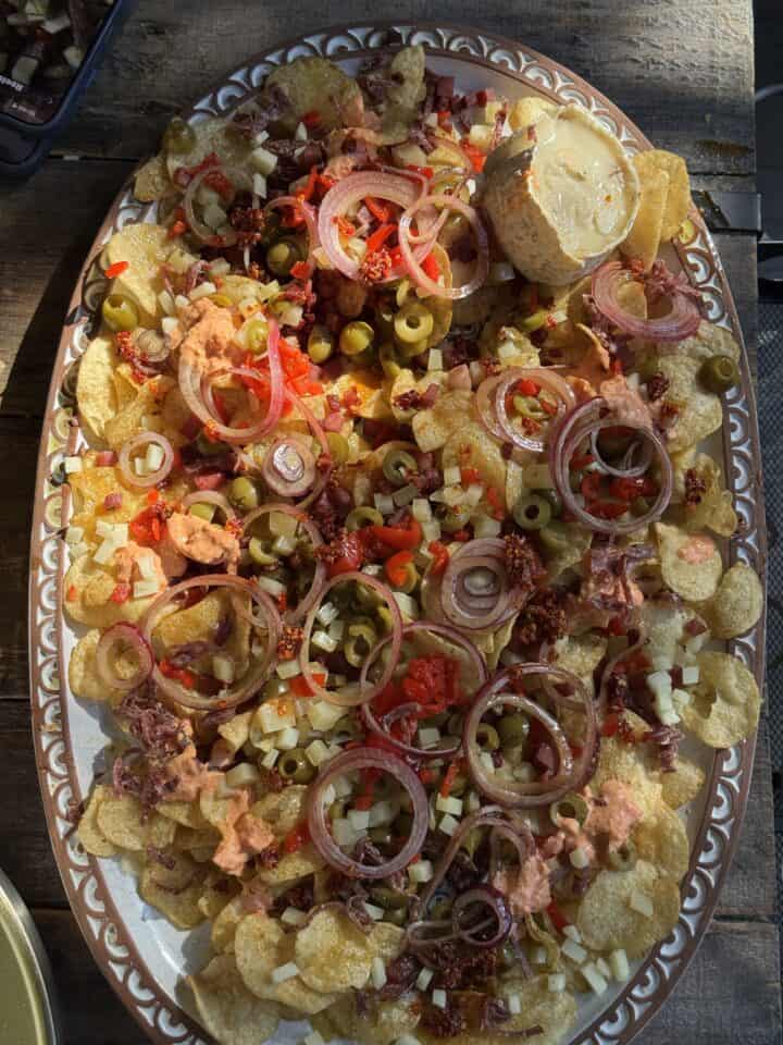Loaded potato chip nachos on a platter