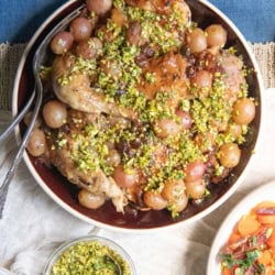 Our Best Chicken Recipe with Wine, Grapes, and Raisins topped with Pistachio Gremolata.