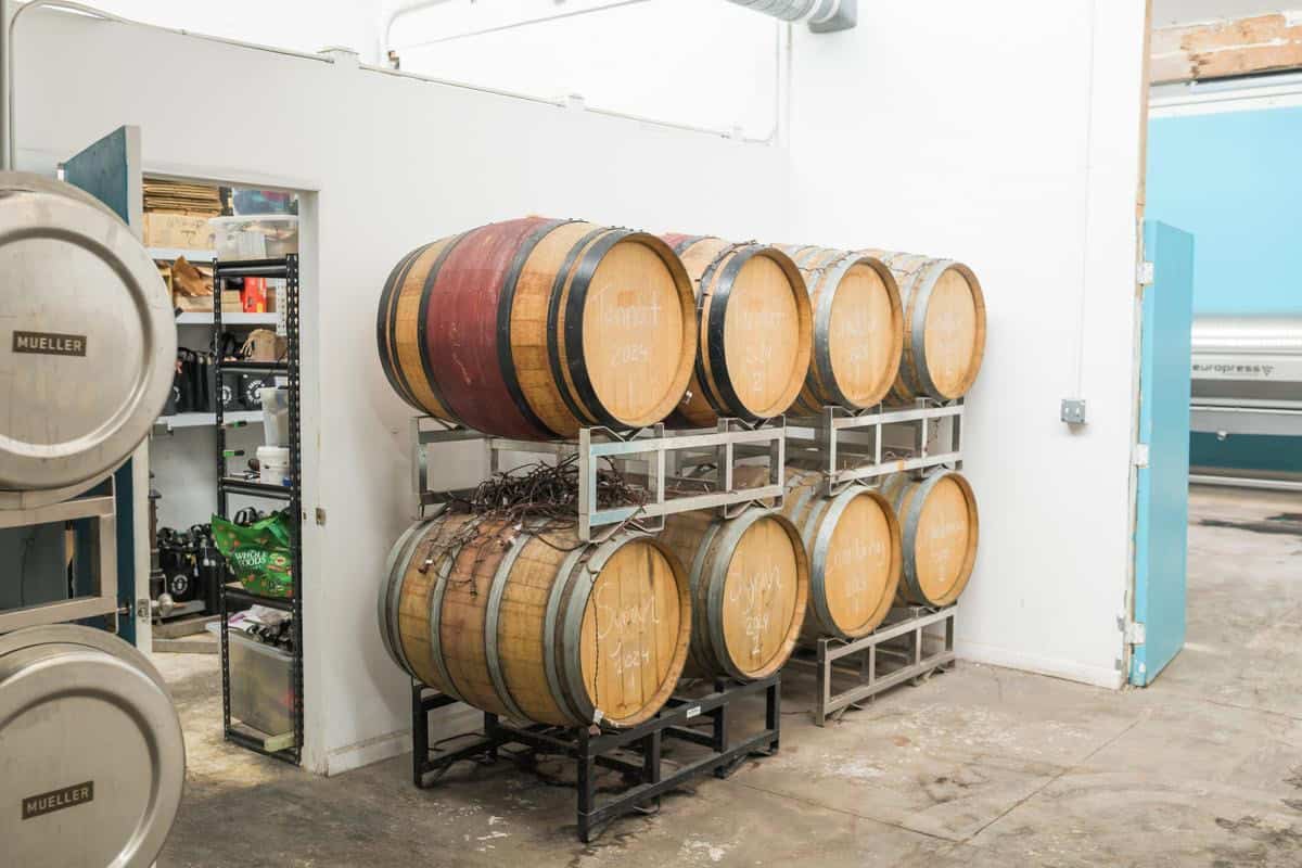 wine barrels against a white wall