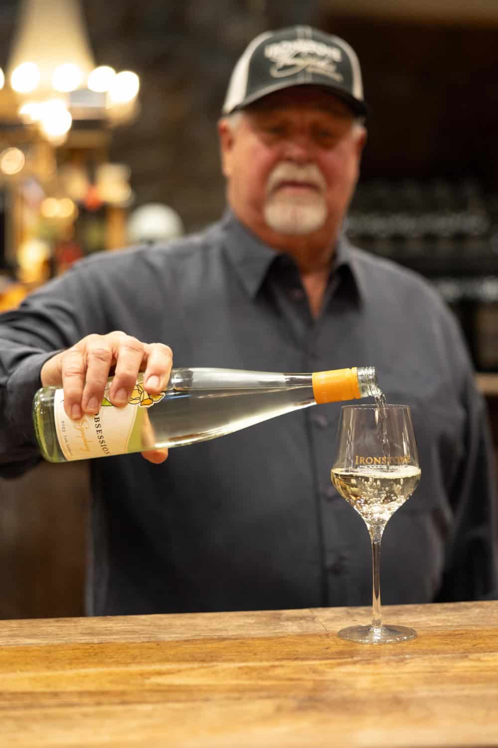Stephen Kautz pouring a glass of Symphony at Ironstone Vineyards