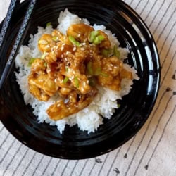 A bowl of Orange Cauliflower and white rice.