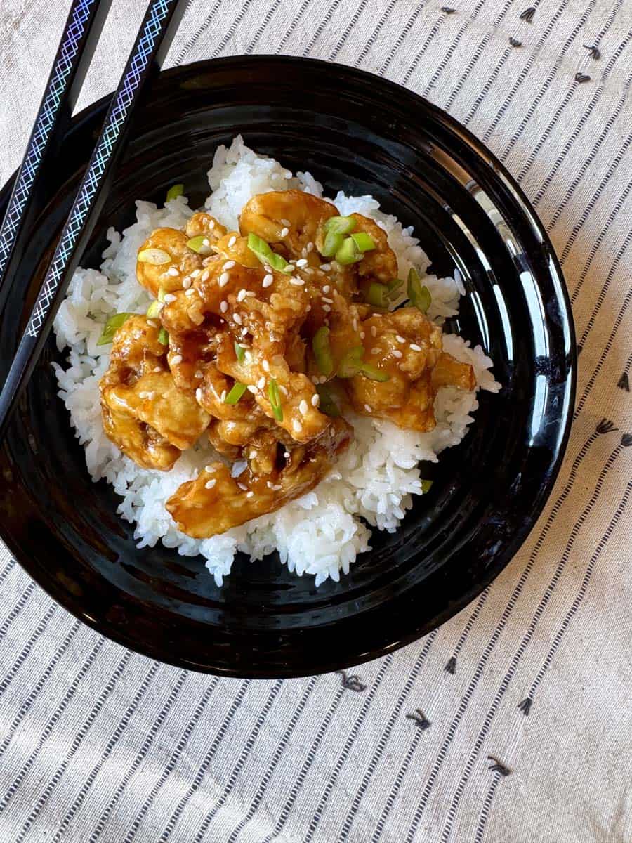 A bowl of Orange Cauliflower and white rice.