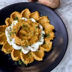 Sweetpotato hummus on a black plate.
