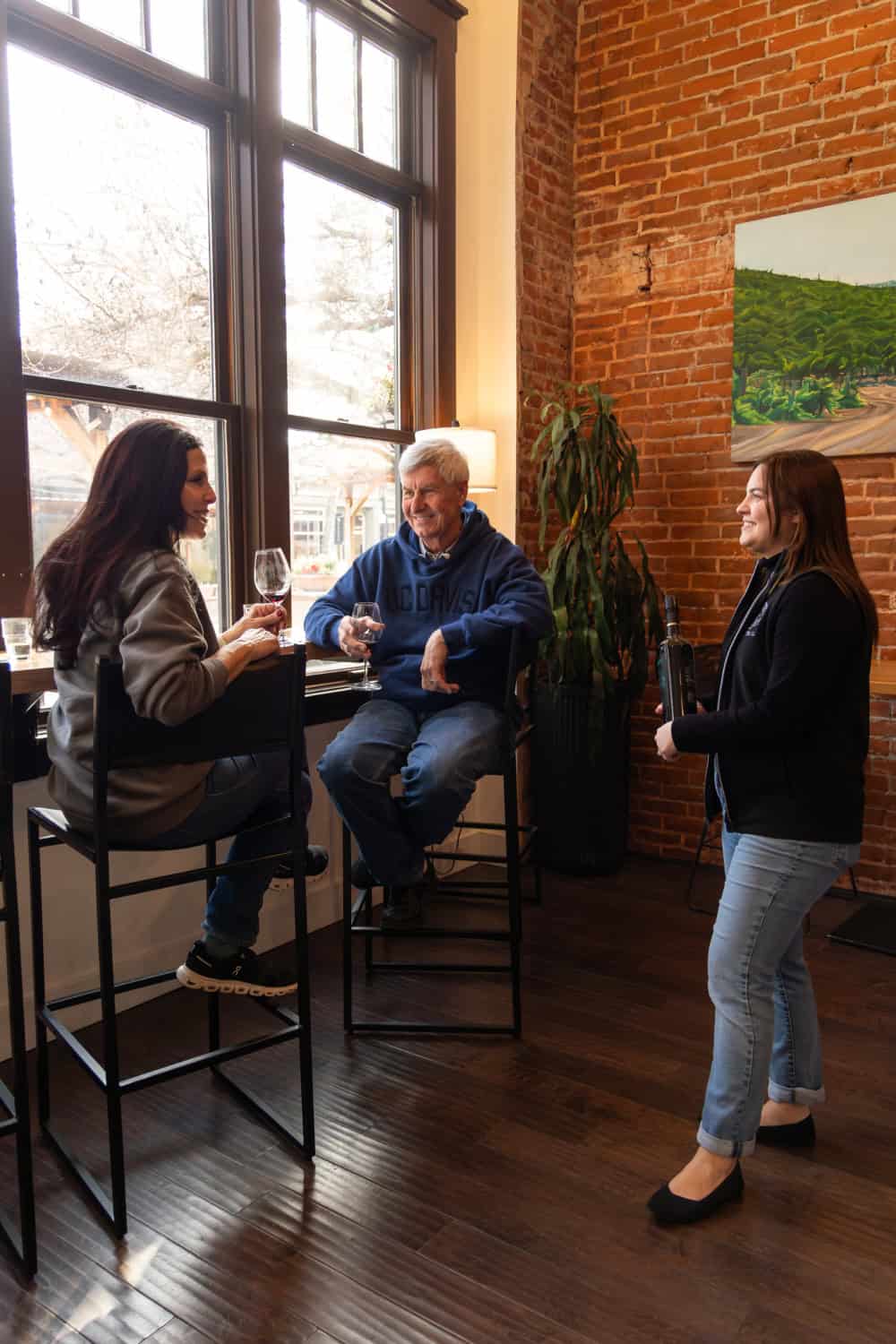 guests enjoying a wine tasting at the downtown Winters tasting room
